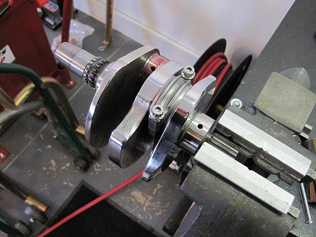 Partway through the crankshaft buildup. Here the crank is held in the vice while all the clearances are checked and bearing sele